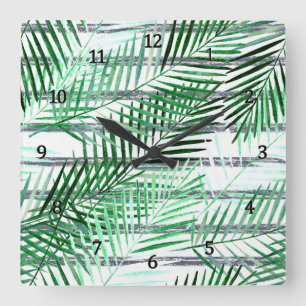 Palmwedel auf einem gestreiften schwarz-weißen Hin Quadratische Wanduhr