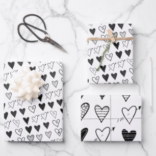 Papierblätter umhüllen Valentinins schwarze Herzen Geschenkpapier Set