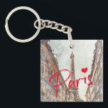 Paris Eiffel Tower Schlüsselanhänger<br><div class="desc">Dieser elegante Schlüsselanhänger verwendet ein Aquarellbild des Eiffelturms, das durch eine Seitenstraße zu sehen ist - Erinnerungen von Reisen in Paris und das französische Straßenleben! Das Wort "Paris" in leuchtend rot mit einem Herz fügt eine schöne, stilvolle und moderne Touch hinzu - Sie können den Text einfach neu formatieren, löschen,...</div>