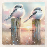 Pastel Watercolor Birds Fencepost Sunset Glasuntersetzer<br><div class="desc">Soft watercolor brushwork captures two fluffy songbirds resting on weathered fence posts as a glowing sunset spreads across a dreamy countryside sky. Gentle washes of peach, blush pink, pale blue, and warm gold blend into a tranquil horizon, creating a calm pastoral atmosphere. The birds appear round and feathery, their delicate...</div>