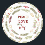 Peace Liebe JoSimple Rustic Christmas Foliage Runder Aufkleber<br><div class="desc">Diese Aufkleber sind ideal für Geschenkverpackungen oder Umschlag Aufkleber und haben eine rustikale Gestaltung von Weihnachtsblättern. Die Formulierung in der Mitte lautet "Peace Liebe and Joy" und ist gerahmt mit Kiefernringen,  Tannenästen,  Weihnachtsschmuck,  Heiligen,  Mistelbeeren und Winterbeeren. Matching Geschenkpackungen und Urlaubskarten sind in unserem Shop erhältlich.</div>