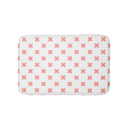 Peach cross stitches auf weiß badematte