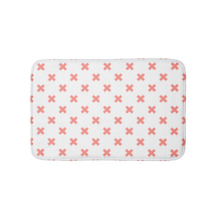 Peach cross stitches auf weiß badematte