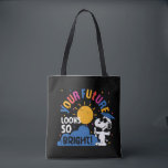 Peanuts Snoopy Your Future Looks So Bright Tasche<br><div class="desc">Celebrate a bright and exciting new chapter with this cheerful Snoopy-inspired graduation design bursting with color and optimism. Set against a bold dark background, this playful artwork features a smiling beagle standing beside a vibrant golden sun rising over soft blue hills, symbolizing new beginnings and endless possibilities. Colorful confetti scatters...</div>