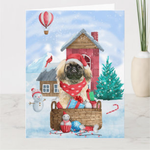 Pekingeser Hund im Schneehundehaus zu Weihnachten Karte