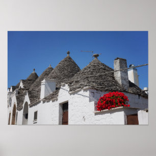 Pelargonie-Blumen und trulli Häuser in Alberobello Poster
