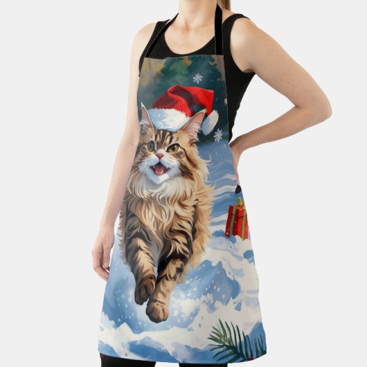 Persische Katze sitzt im Schnee mit Weihnachtshut Schürze (InSitu)