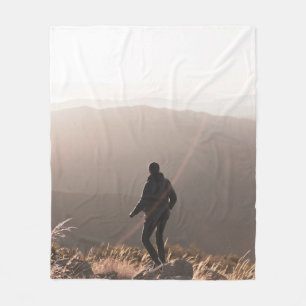 Person standing on rock fleecedecke
