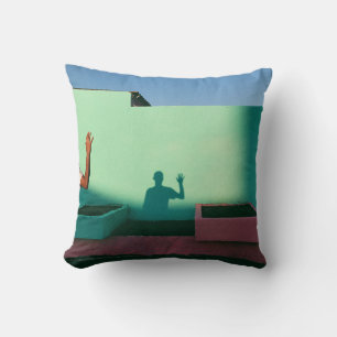 Person waving reflecting shadow on teal wall paint kissen