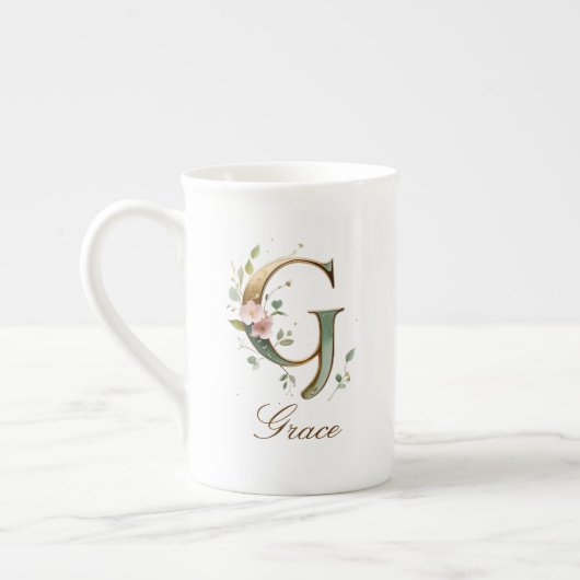 Personalisierte goldene Blumenmonogramm-Initiale G Porzellantasse (Links)