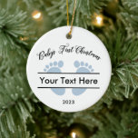 Personalisiertes Baby's First Christmas Keramik Ornament<br><div class="desc">Personalisieren Sie Ihren Weihnachtsbaum mit diesem hübschen Baby's First Christmas Sake Ornament. Ein lustiges Weihnachtsdesign mit einer Baby Füße Silhouette in blau für Jungs. Personalisieren Sie dieses Ornament mit dem Namen des Babys oder jedem Text,  den Sie wählen,  zusammen mit dem entsprechenden Jahr.</div>