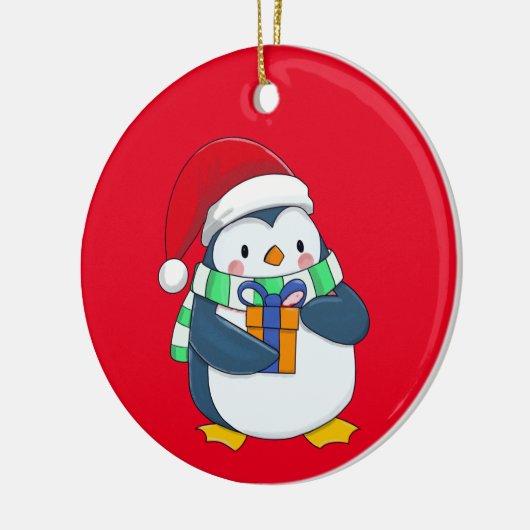 Pinguin in einem Weihnachtshut mit Geschenk Keramik Ornament (Links)