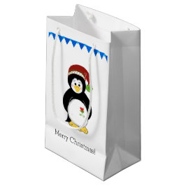 Pinguin in einer Weihnachtsmannmütze Kleine Geschenktüte