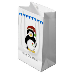 Pinguin in einer Weihnachtsmannmütze Kleine Geschenktüte