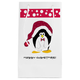 Pinguin in einer Weihnachtsmannmütze Kleine Geschenktüte