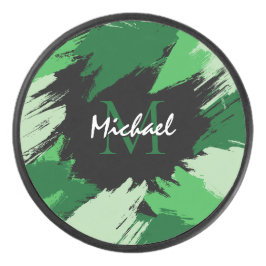 Pinselstriche in grünen Farbtönen mit Monogramm Eishockey Puck