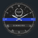 Police Styled American Flag Badge and Name Große Wanduhr<br><div class="desc">An der Wall clock featuring a blue line American flag symbollic of law-enforcement. Roman numerals and a spot for yours or your gift recipient badge number and last name.</div>