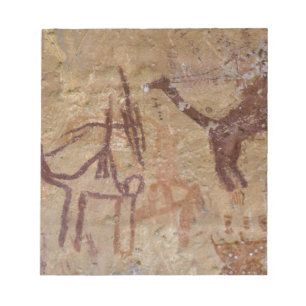 Prähistorische Felsmalereien mit Kamelen und Notizblock