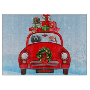 Pudel im Auto mit dem Weihnachtsmann  Schneidebrett