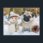 Pug Sitting Next to Snowman in Winter Postkarte<br><div class="desc">pug sitting beside a snowman in a winter setting, capturing playful interaction in the snow.</div>