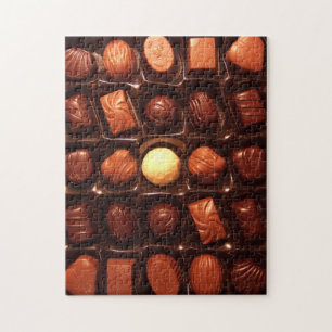 Puzzle, das Kasten der Praline kennzeichnet Puzzle