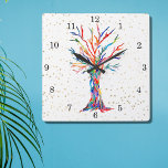 Rainbow Tree Gold Stars Quadratische Wanduhr<br><div class="desc">Diese skurrile Uhr ist mit einem Ausdruck eines Baumes des Lebens in Regenbogenfarben und goldenen Sternen dekoriert. Der Baum wurde ursprünglich aus Mosaik mit winzigen Fragmenten aus Glas in lebhaften Farben hergestellt. Weil wir unsere eigenen Kunstwerke erstellen, werden Sie dieses exakte Bild von anderen Designern nicht finden. Original Mosaik ©...</div>