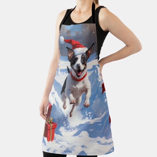 Rat Terrier läuft im Schnee mit Weihnachtshut Schürze (InSitu)