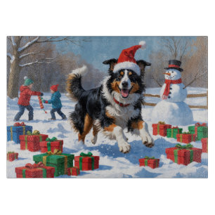 Raucollie läuft im Schnee mit Weihnachtsmütze Schneidebrett