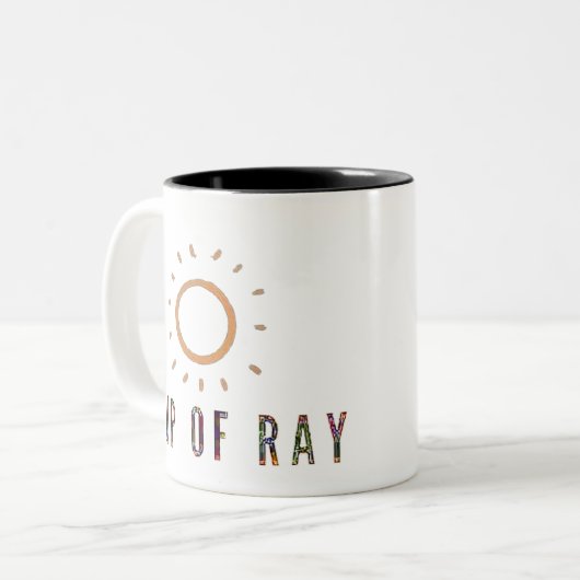 Ray Cup. Künstlerisches Logo Zweifarbige Tasse (Vorderseite Links)