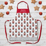 Red Christmas Nutcracker Pattern Schürze<br><div class="desc">Die Schürze wird durch ein einfaches Muster eines Weihnachtslieders in Rot,  Schwarz und Silber geschmückt. Macht ein lustiges Weihnachtsgeschenk. Personalisieren Sie es mit Ihrem Namen in dieser Weihnachtszeit. Entworfen für Sie von BlackBerry Boulevard.</div>