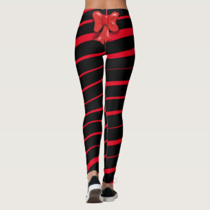 RED CHRISTMAS RIBBON UND BODEN AUF SCHWARZ LEGGINGS