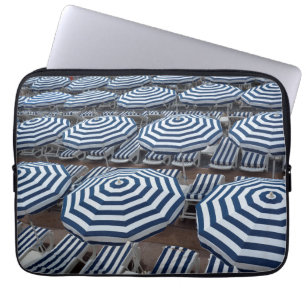 Reihen der gestreiften Strandschirme mit Laptopschutzhülle