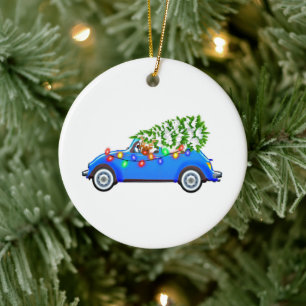 Reindeer driving a beetle with christmas treeb keramik ornament