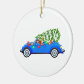Reindeer driving a beetle with christmas treeb keramik ornament (Links)