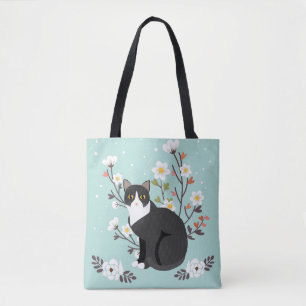Reizende Tuxedo-Katze in den Blumen ganz vorbei - Tasche