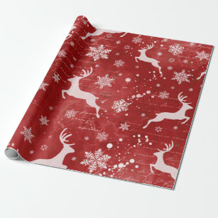 Rentiere und Schneeflocken im roten Hintergrund Geschenkpapier