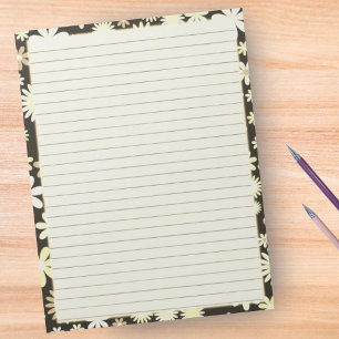 Retro-Blumenrand auf vintage-gelbem Linienpapier Notizblock