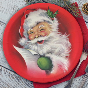 Retro zwinkerndem Weihnachtsmann, der seine Liste Pappteller