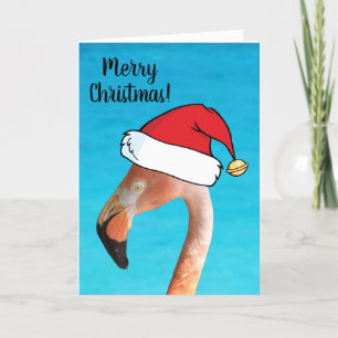Rosa Flamingo in rotem Cartoon Weihnachtsmannmütze Feiertagskarte