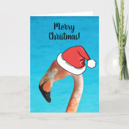 Rosa Flamingo in roter Cartoon Weihnachtsmannmütze Feiertagskarte