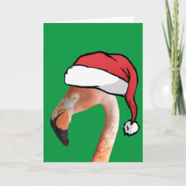 Rosa Flamingo in roter Cartoon Weihnachtsmannmütze Feiertagskarte