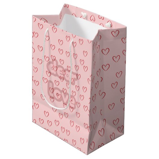 Rosa Geschenktüte mit Herz-Muster (Vorderseite Schrägansicht)