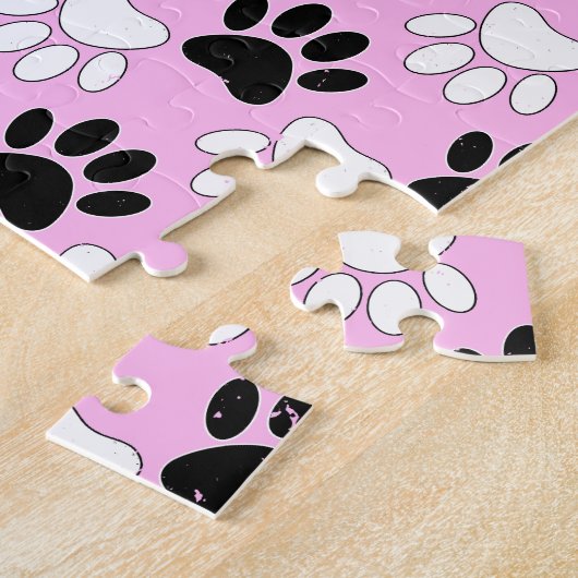Rosa Untergrund: erschütterte schwarz-weiße Paws Puzzle (Seite)