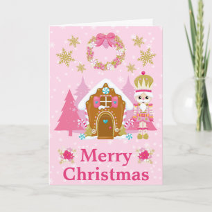 Rosa Weihnachtsnussknacker und Lebkuchenhäuschen Feiertagskarte