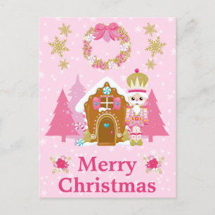Rosa Weihnachtsnussknacker und Lebkuchenhäuschen Feiertagspostkarte