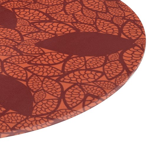 Rot verlässt Muster auf Orange Schneidebrett (Ecke)