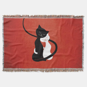 Rote niedliche weiße und schwarze Katzen in der Decke