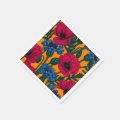 Rote Pfeffer und blaue Kornblumen auf Orange Serviette (Ecke)