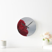 Rote Rosen gegen einen hellen blauen Himmel Runde Wanduhr (Zuhause)