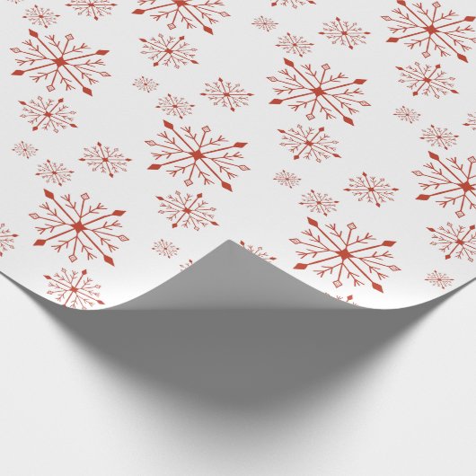 Rote Schneeflocken im Weißbuch Geschenkpapier (Ecke)